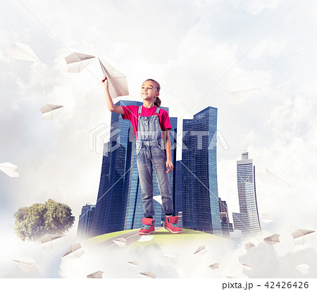 Concept of careless happy childhood with girl dreaming about future 42426426