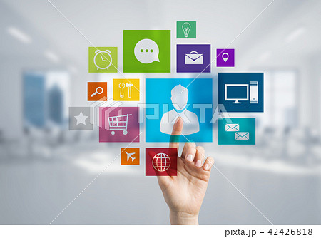 Modern office interior and close of businesswoman hand choosing icon on multimedia interface Modern office interior and close of businesswoman hand choosing icon on multimedia interface 42426818