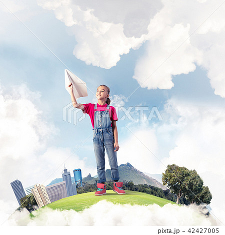 Concept of careless happy childhood with girl dreaming about future 42427005