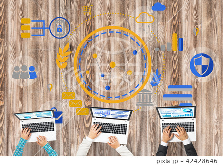 Top view of businesspeople sitting at table and using gadgets Top view of businesspeople sitting at table and using gadgets 42428646