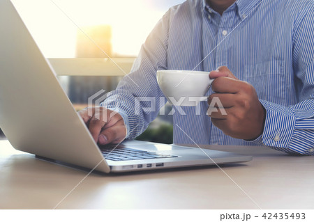 business man is using laptop in coffee shop business man is using laptop in coffee shop 42435493