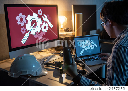 Technician using screwdriver for repairing drone 42437276