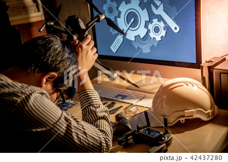 Technical engineer feeling stressed while repairing drone 42437280
