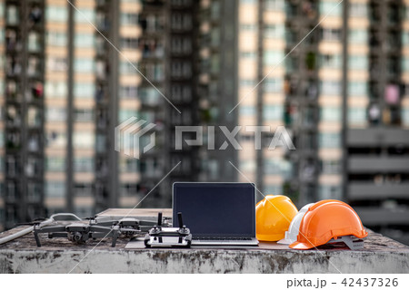 Drone, laptop and helmet at construction site 42437326