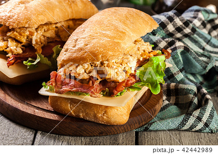 Ciabatta sandwich with smoked bacon and eggs Ciabatta sandwich with smoked bacon and eggs 42442989
