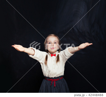 Little girl having fun on empty blackboard Little girl having fun on empty blackboard 42448466