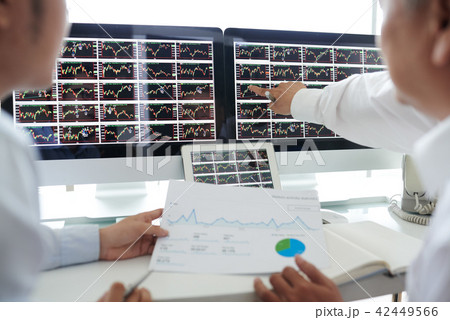 Investors analyzing data Investors analyzing data 42449566