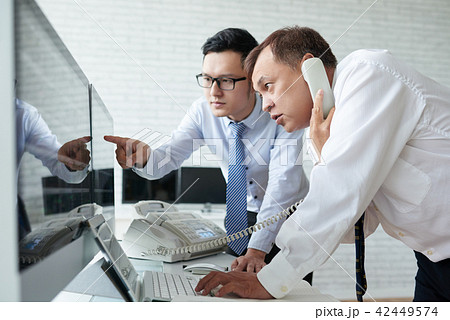 Traders working at stock exchange Traders working at stock exchange 42449574