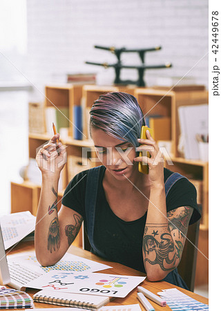 Graphic designer calling on phone Graphic designer calling on phone 42449678