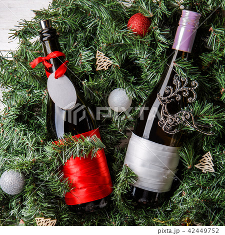 Photo of spruce branches with two bottles of wine, blank greeting card 42449752