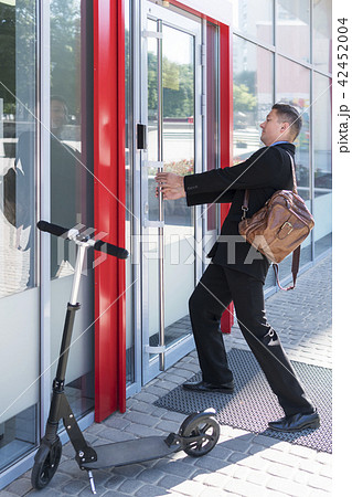 Businessman is pulling the door 42452004