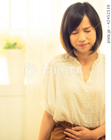 Young woman with stomachache Young woman with stomachache 42452539