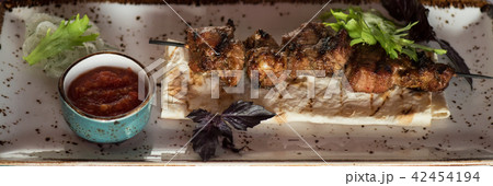 shashlik on a barbecue skewer with sauce shashlik on a barbecue skewer with sauce 42454194