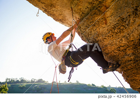 Image of tourist man in helmet clambering up Image of tourist man in helmet clambering up 42456906
