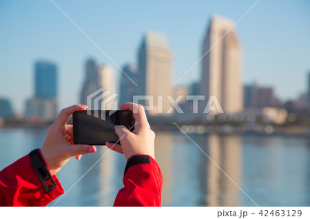 Female hands with a phone close-up. Street photo. 42463129