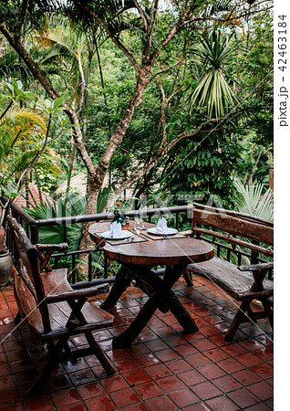 Asian outdoor living area with wooden benches Asian outdoor living area with wooden benches 42463184