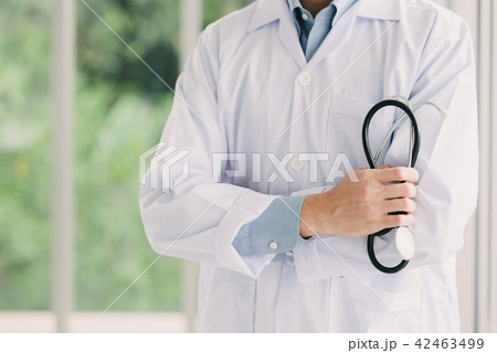 Doctor with arms crossed holding stethoscope 42463499