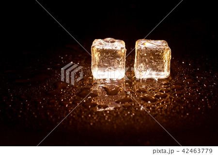 Golden ice cubes on black background. Golden ice cubes on black background. 42463779