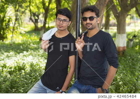 Two handsome men in casual clothes in park Two handsome men in casual clothes in park 42465484