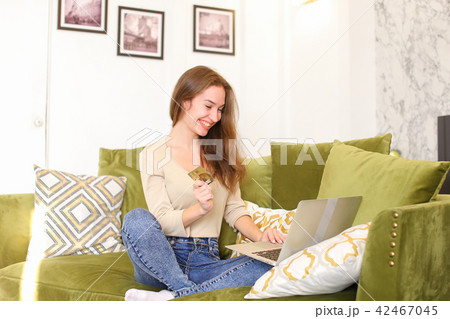 journalist female using laptop bank card to book tickets. journalist female using laptop bank card to book tickets. 42467045