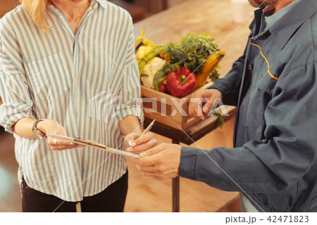 Top view photo of two people that holding folder Top view photo of two people that holding folder 42471823