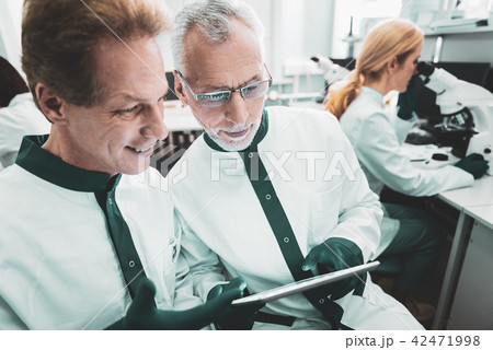 Two male biologists standing near woman in uniform 42471998