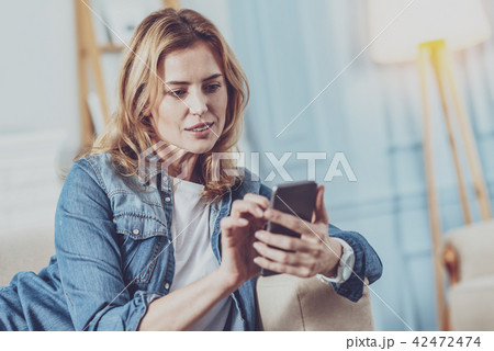 Concentrated female person typing message Concentrated female person typing message 42472474