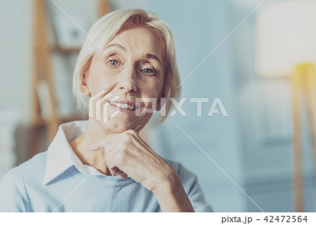 Cheerful elderly woman posing on camera 42472564