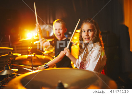 boy and girl play drums in recording studio boy and girl play drums in recording studio 42474139