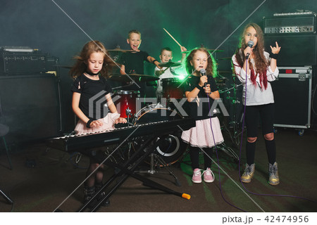 happy children singing and playing music 42474956