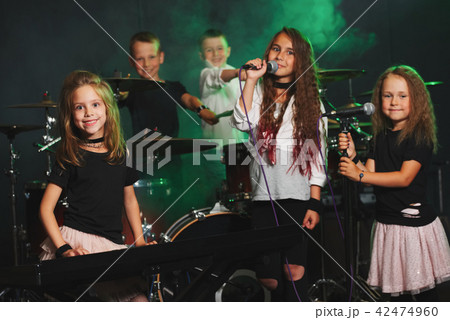 happy children singing and playing music 42474960