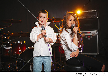boy and girl singing in recording studio 42475023