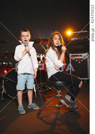 boy and girl singing in recording studio boy and girl singing in recording studio 42475032