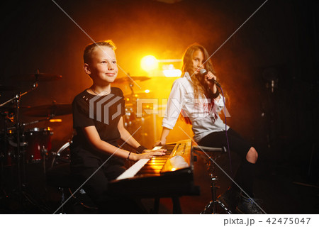 children singing and playing music in recording studio 42475047