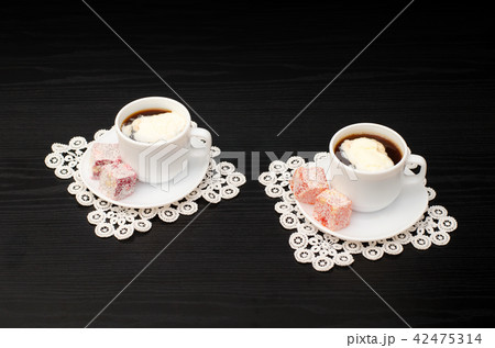 View at an angle into two mugs of coffee View at an angle into two mugs of coffee 42475314