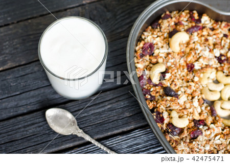 Glass of yogurt and granola with cashews Glass of yogurt and granola with cashews 42475471