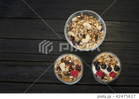 Granola with cashew in a cup with yoghurt Granola with cashew in a cup with yoghurt 42475617