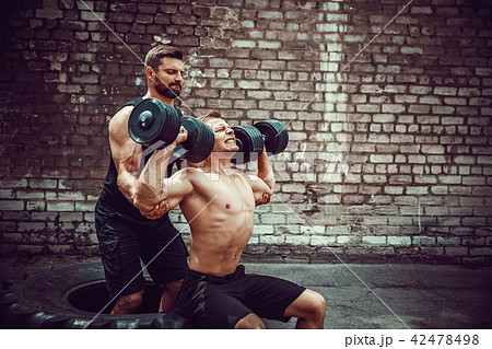 Two muscular athletes training 42478498