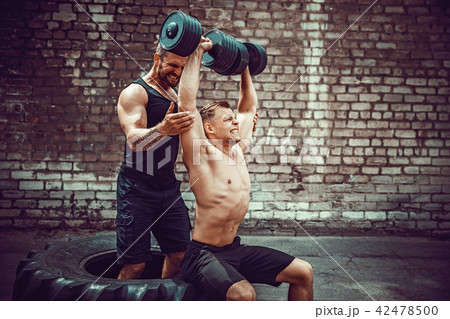 Two muscular athletes training 42478500