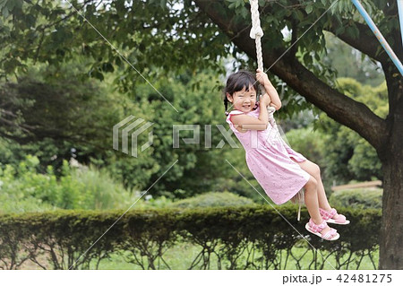 Girls Playing With Tarzan Rope Stock Photo