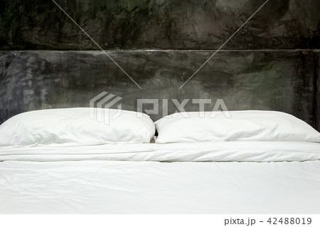 White pillows on a bed and bedding sheets on bed White pillows on a bed and bedding sheets on bed 42488019