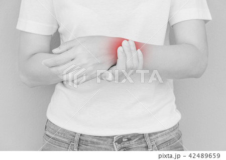 Woman scratching her elbow. 42489659