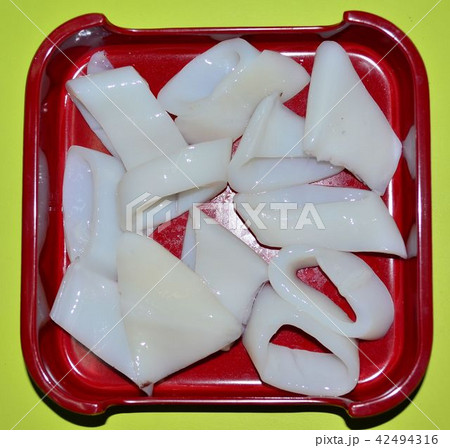 Squid pieces in a red tray. Squid pieces in a red tray. 42494316