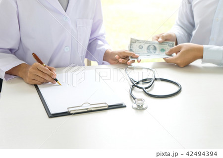 Business man or patient give bribe to the docto Business man or patient give bribe to the docto 42494394