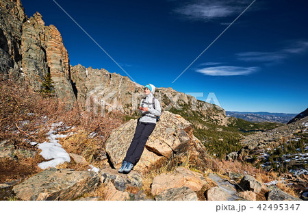 Woman tourist on a trail in Rocky Mountains 42495347