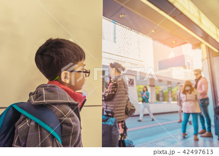 asian boy waiting in public park . 42497613