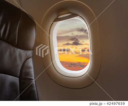 seat and plane window with beautiful blue sky. seat and plane window with beautiful blue sky. 42497639