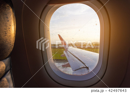 seat and plane window with raindrops. 42497643