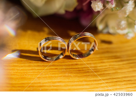 Beautiful toned picture with wedding rings lie on 42503960