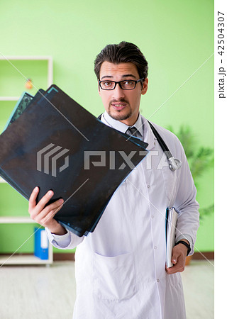 Doctor radiologist looking at x-ray scan in hospital 42504307